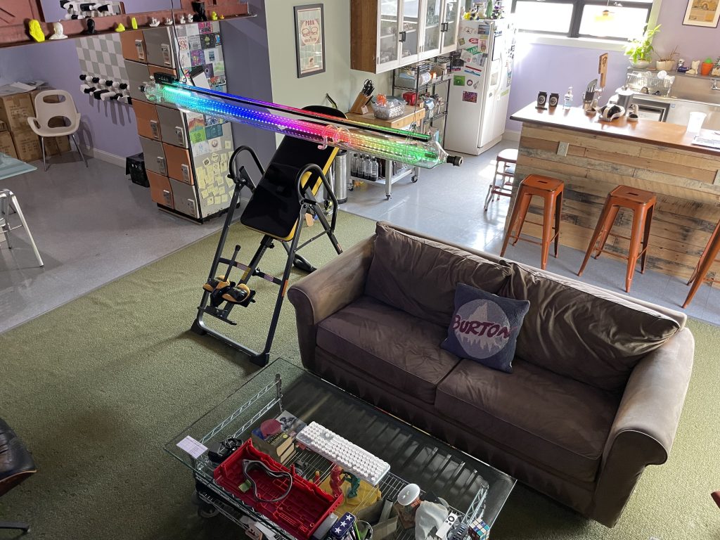Repurposed laser tube lamp hanging in employee kitchen/lounge.
